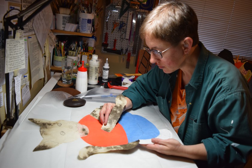 creating a cat character out of cut handmade paper for a public art project