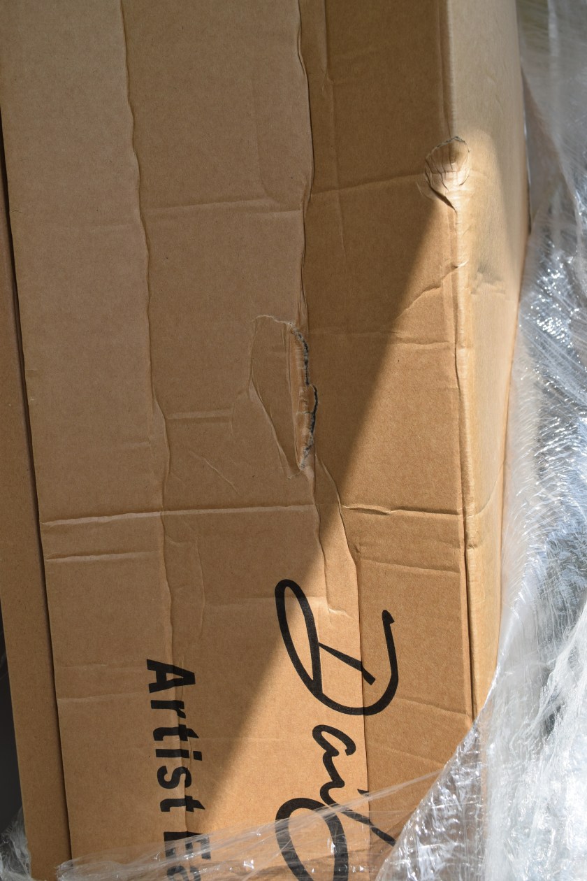 Oh no! The box is crushed and punctured in places! Will the easel inside be okay?