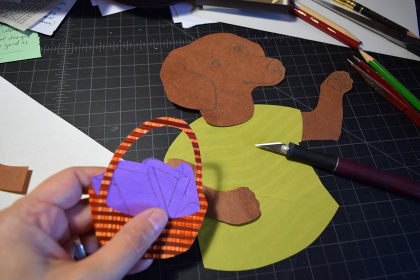 Sue Clancy assembling  a fine art piece with her hand dyed papers that have been cut out in different shapes.